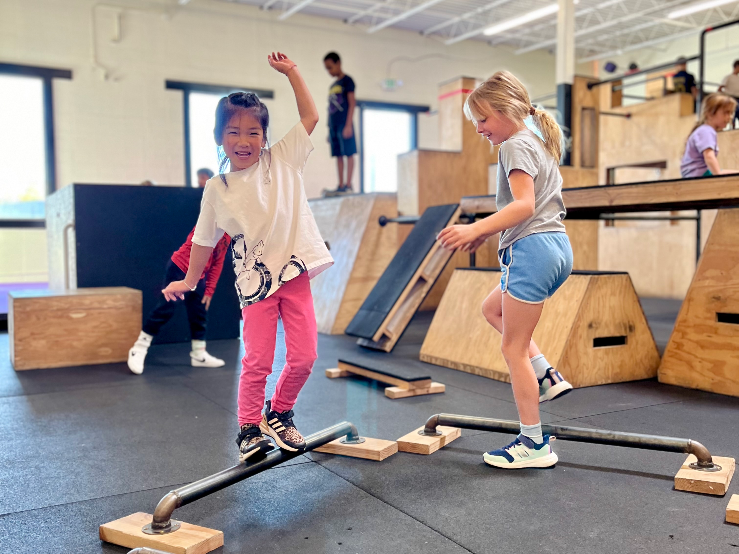Student jumping on trampoline with coach guidance at Superhuman Academy in Boulder